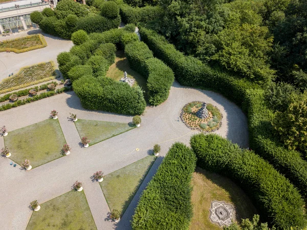 Aerial view of a statue and a flowering garden with flowerbeds and vases, Villa Arconati, Castellazzo, Bollate, Milan, Italy. — Stock Photo, Image