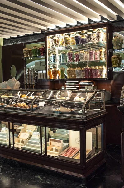 Italy: the crystal tees of the counter at the Pasticceria Marchesi, historic pastry shop in Milan since 1824, opened in 2016 inside the Prada boutique in the Galleria Vittorio Emanuele II — Stock Photo, Image