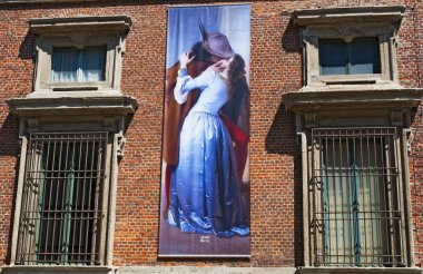 Italy: poster of The Kiss, a 1859 painting by Francesco Hayez, on the exterior wall of Palazzo Brera, palace housing the Pinacoteca di Brera, the main public gallery for paintings in Milan clipart