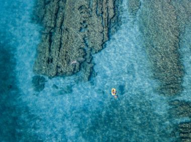 Şeffaf bir denizde yüzen su kanoyla hava görünümünü. Yıkananlara denizde. Zambrone, Calabria, İtalya. Dalış dinlenme ve yaz tatil. İtalyan kıyıları, plajları ve kayalar