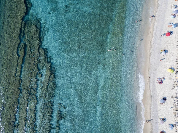 Vista aérea das rochas no mar. Visão geral do fundo do mar visto de cima, água transparente. Nadadores, banhistas que flutuam na água — Fotografia de Stock