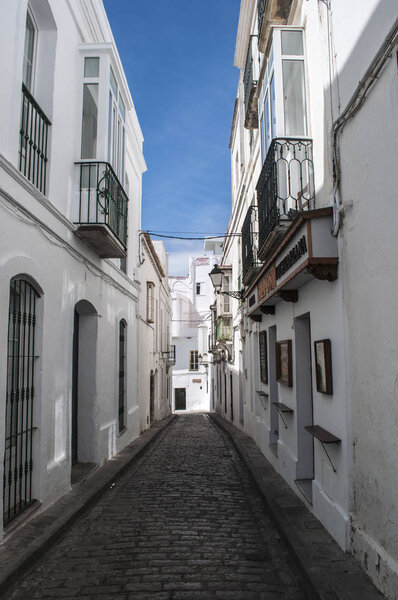 Spain, 23/04/2016: the white houses in the alleys of the old city of Tarifa, the town on the southernmost coast of the mainland facing the Strait of Gibraltar and Morocco, known as the windy city
