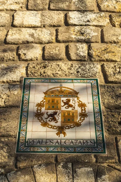 Spain: the sign of the Alcazar of Seville, the famous royal palace originally developed by Moorish Muslim kings, one of the most outstanding examples of mudejar architecture — Stock Photo, Image