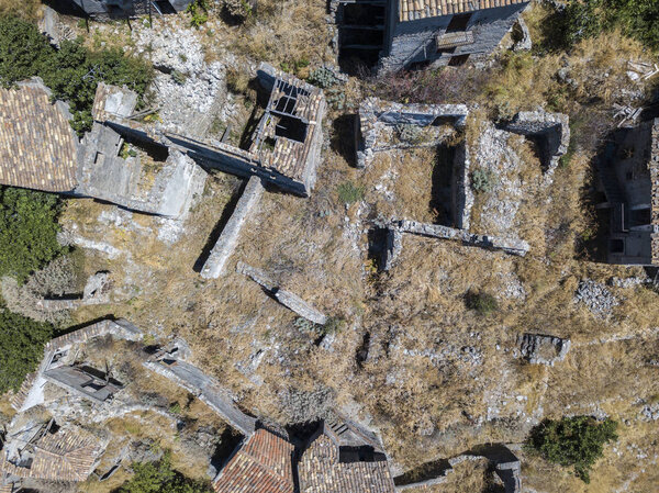 Aerial view of the Small village of Pentedattilo, church and ruins of the abandoned village, Greek colony on Mount Calvario, whose form recalls the five fingers
