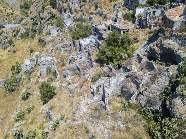 Aerial view of the Small village of Pentedattilo, church and ruins of the abandoned village, Greek colony on Mount Calvario, whose form recalls the five fingers