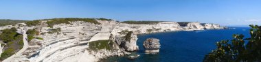Corsica: view of the breathtaking white limestone cliffs of Bonifacio at the southern tip of the island in front of the Strait of Bonifacio, the stretch of sea between Corsica and Sardinia clipart