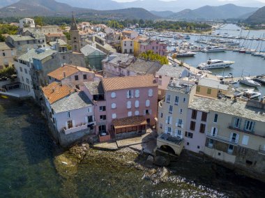 Aerial view of the village of Saint Florent, Corsica. France. Harbor boats and houses clipart