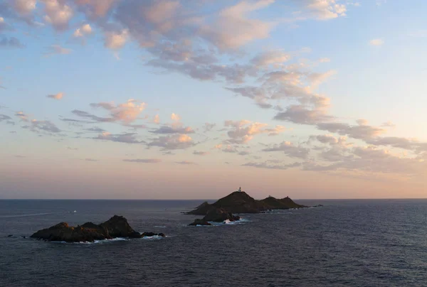 Korsika: hisnande solnedgången på den Iles Sanguinaires (blodiga öarna), berömda fyra mörk röd porfyr öar, en liten skärgård i golfen Ajaccio med en fyr som dating 1844 — Stockfoto