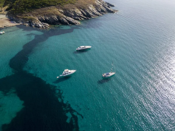 Aerial view of moored boats floating on a transparent sea. Diving relaxation and summer vacations. French Riviera, Corsica. France — Stock Photo, Image
