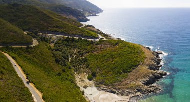 Korsika sahil dolambaçlı yollar ve koyları ile kristal deniz hava görünümünü. Cap Corse Yarımadası, Corsica. Kıyı şeridi. Anse d'Aliso. Aliso Körfez. Fransa