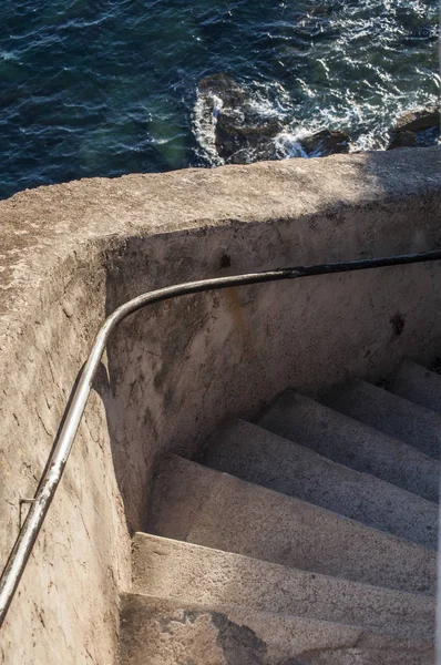 Corsica, 05/09/2017: the first steps of the Staircase of the King of Aragon (Escalier du Roi dAragon), a stony staircase of 187 steps carved into the vertical side of a limestone cliff in Bonifacio