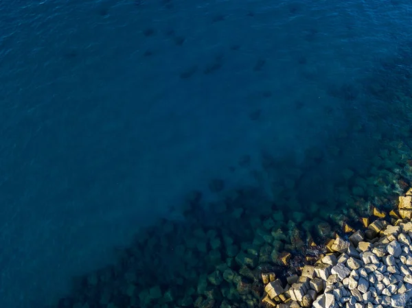 Aerial view of a seabed with rocks emerging from the sea, seabed seen from above, transparent water. Pizzo Calabro, Calabria, Italy