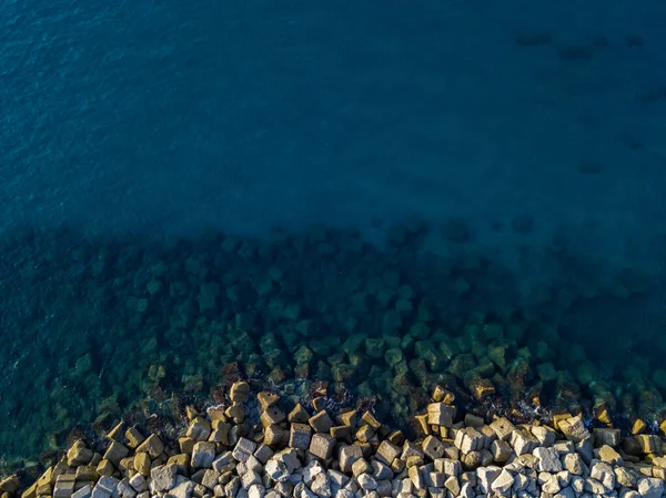 Aerial view of a seabed with rocks emerging from the sea, seabed seen from above, transparent water. Pizzo Calabro, Calabria, Italy