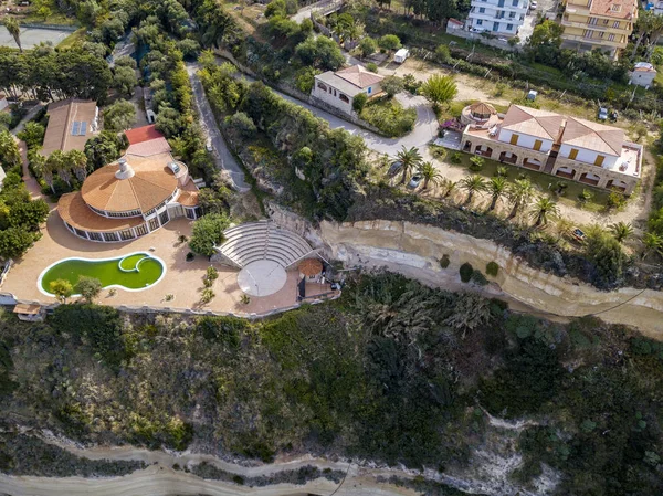 Aerial view of the Calabrian coast, villas and resorts on the cliff. Transparent sea and wild coast. Locality of Riaci near Tropea, Calabria. Italy