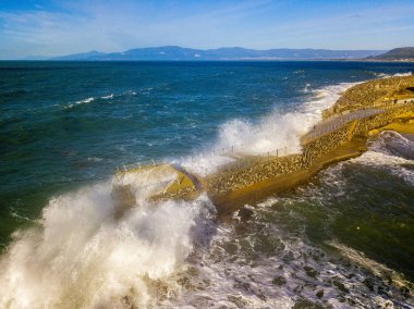 Denizde kaya ve kayalarla dolu bir rıhtımın havadan görünüşü. Pizzo Calabro iskelesi, yukarıdan panoramik manzara. Kırık iskele, denizin gücü. Dalgaların Gücü. Doğal felaketler, iklim değişikliği. Calabrian kıyıları, Güney İtalya. Calabria