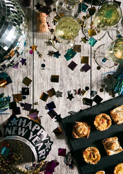 Nový rok: Zpětný pohled stůl s předkrmy a korunu Nye — Stock fotografie
