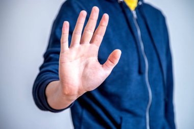 Defense or stop gesture: Male hand with stop gesture