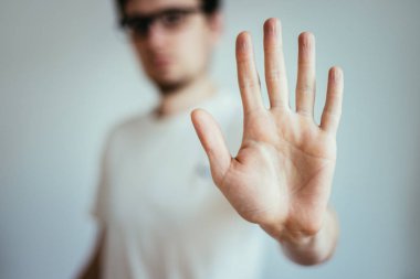 Defense or stop gesture: Male hand with stop gesture