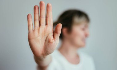 Defense or stop gesture: Girl hand with stop gesture