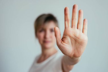 Girl showing stop gesture, close up of the hand