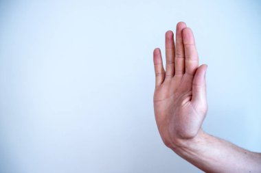 Defense or stop gesture: Male hand with stop gesture