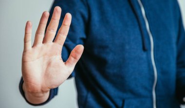 Defense or stop gesture: Male hand with stop gesture
