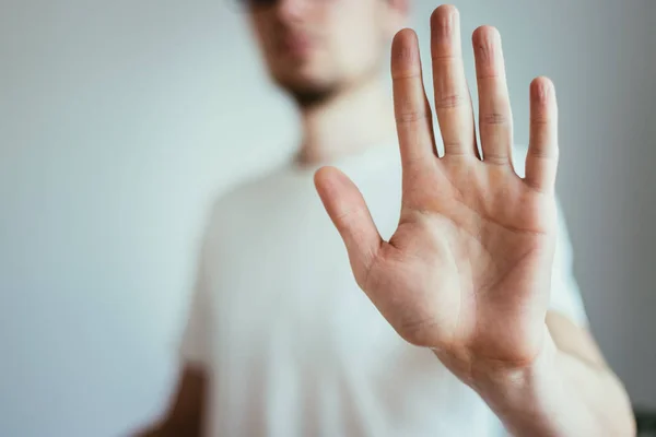 Defense or stop gesture: Male hand with stop gesture