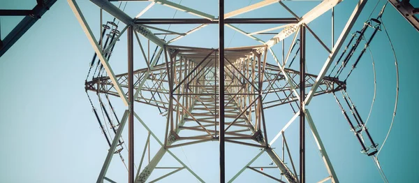 Close up of electrical tower and blue sky. Renewable energy and