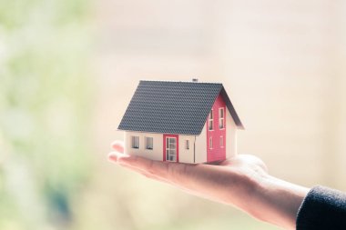 Yeni ev ve ev konsepti: Kırmızı ev modeli erkek elinde