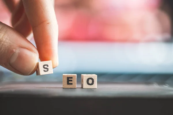 Wood cubes with the word SEO,  picture with copy space. Search engine optimization.