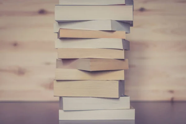 Stack of books on wooden background, knowledge and science