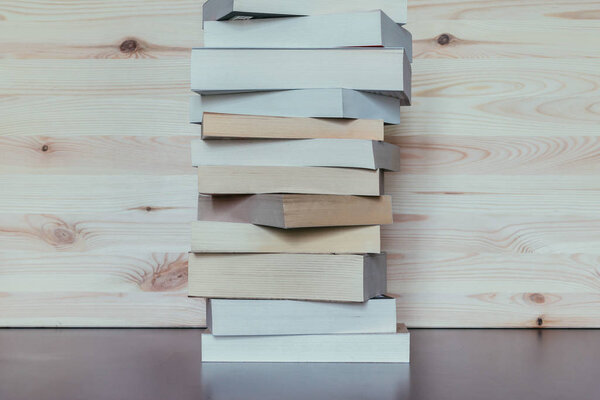 Stack of books on wooden background, knowledge and science 