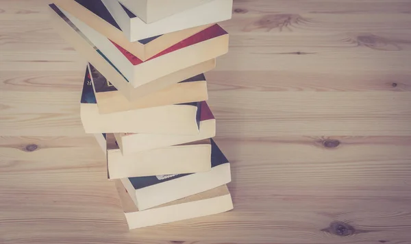 Stack of books on wooden background, knowledge and science