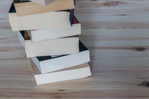 Stack of books on wooden background, knowledge and science