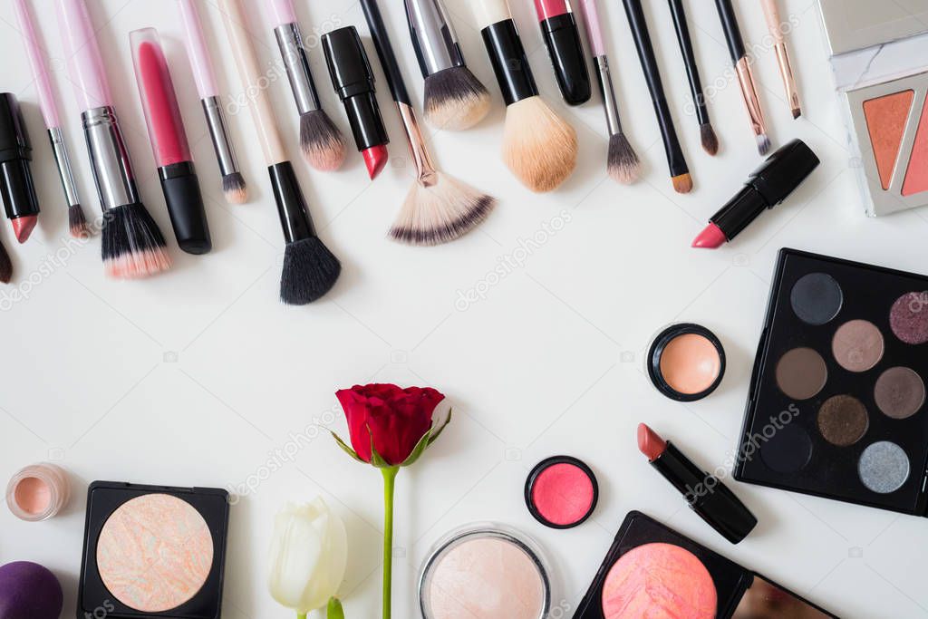 Set of makeup brushes and other accessories. Lipstick, mascara, nail polish, eyeshadow, powder, eyelash and foundation. Products for makeup on white background, top view. 