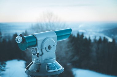 Close up of tourist binocular in Austria, wintertime and sundown