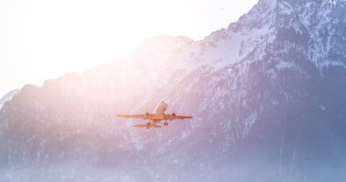 Aircraft is taking off, idyllic mountain range in the background