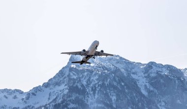 Aircraft is taking off, idyllic mountain range in the background