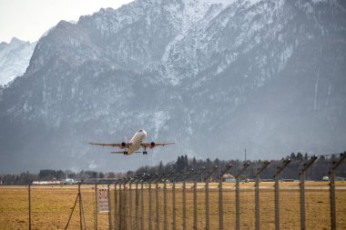 Aircraft is taking off, idyllic mountain range in the background