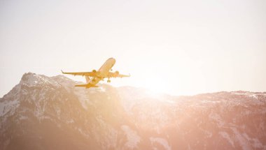 Aircraft is taking off, idyllic mountain range in the background