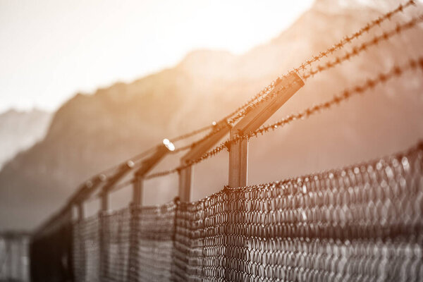 Military fence, demarcate the border, closeup, blurry background