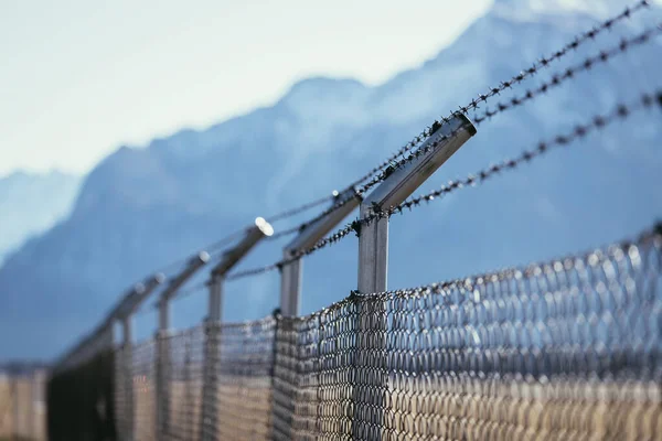 Military fence, demarcate the border, closeup, blurry background