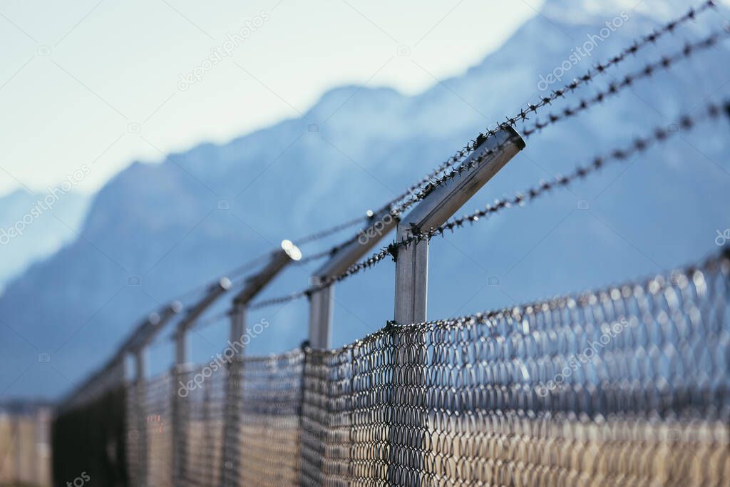 Military fence, demarcate the border, closeup, blurry background