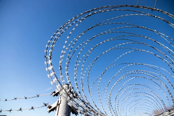 Military fence, demarcate the border, closeup, blurry background