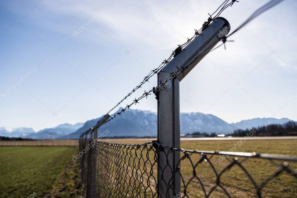 Military fence, demarcate the border, closeup, blurry background