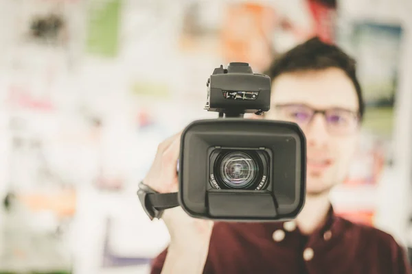 Hombre Camarógrafo Está Sosteniendo Una Videocámara Profesional Fondo Borroso — Foto de Stock