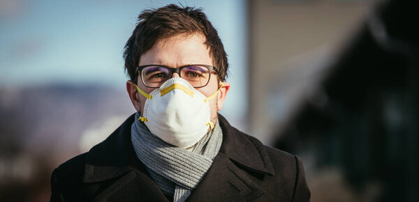 Young man outdoors with a breathing mask. Flue and corona season