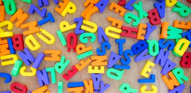 Close up of colorful toy letters in the kindergarten clipart