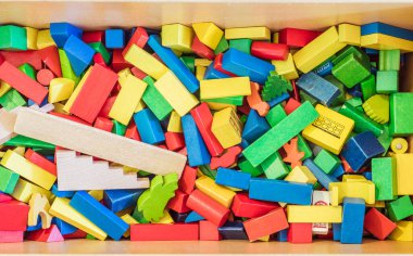 Colorful wooden toy blocks in a box clipart