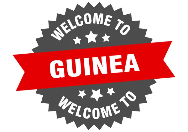 Firma Guinea. Benvenuti in Guinea adesivo rosso — Vettoriale Stock